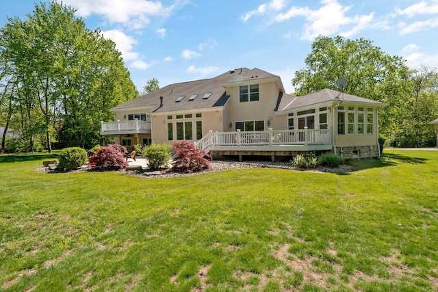 504 W Orange Rd, Delaware, OH 43015 - rear view of house with a wooden deck, a lawn, a sunroom, and stucco siding