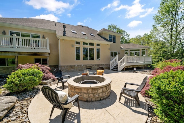 504 W Orange Rd, Delaware, OH 43015 - back of property featuring an outdoor fire pit, a patio area, stucco siding, stone siding, and a wooden deck