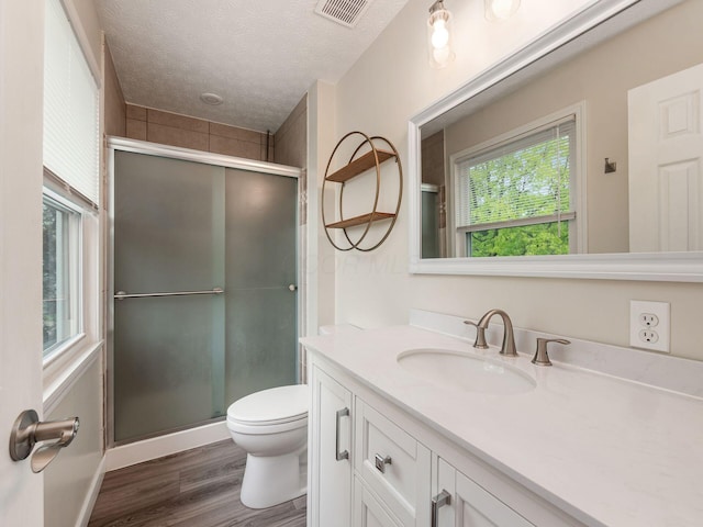 1520 Dickson Dr, Columbus, OH 43228 - full bath featuring a shower stall, wood finished floors, vanity, toilet, and a textured ceiling