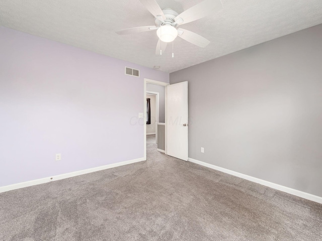 1520 Dickson Dr, Columbus, OH 43228 - empty room featuring carpet flooring, baseboards, a ceiling fan, and a textured ceiling