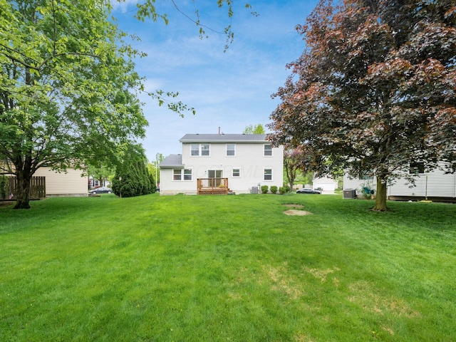1520 Dickson Dr, Columbus, OH 43228 - back of house featuring a lawn, a deck, and central AC