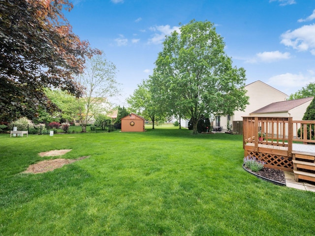 1520 Dickson Dr, Columbus, OH 43228 - view of yard featuring a wooden deck, an outbuilding, and a storage unit