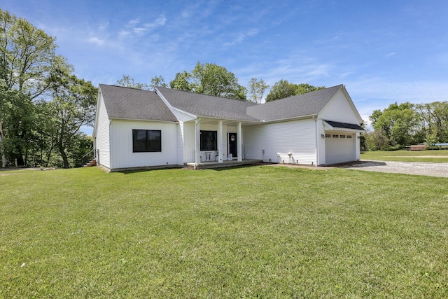 7205 W Grubb Rd NE, Thornville, OH 43076 - view of front of property with driveway, a garage, a porch, a front yard, and a shingled roof