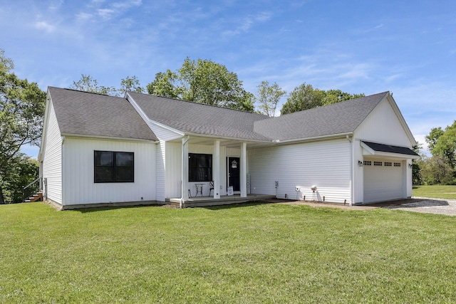 7205 W Grubb Rd NE, Thornville, OH 43076 - view of front of house with an attached garage, a porch, driveway, a front yard, and a shingled roof