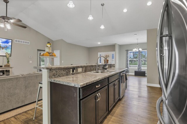 7205 W Grubb Rd NE, Thornville, OH 43076 - kitchen with stainless steel appliances, open floor plan, a sink, a breakfast bar area, and ceiling fan