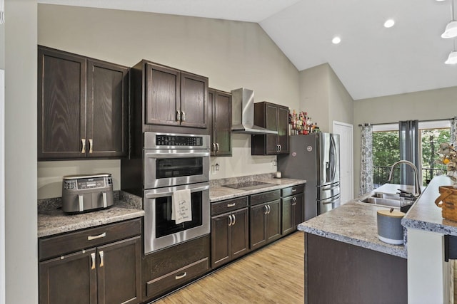 7205 W Grubb Rd NE, Thornville, OH 43076 - kitchen featuring a sink, wall chimney range hood, lofted ceiling, appliances with stainless steel finishes, and dark brown cabinetry