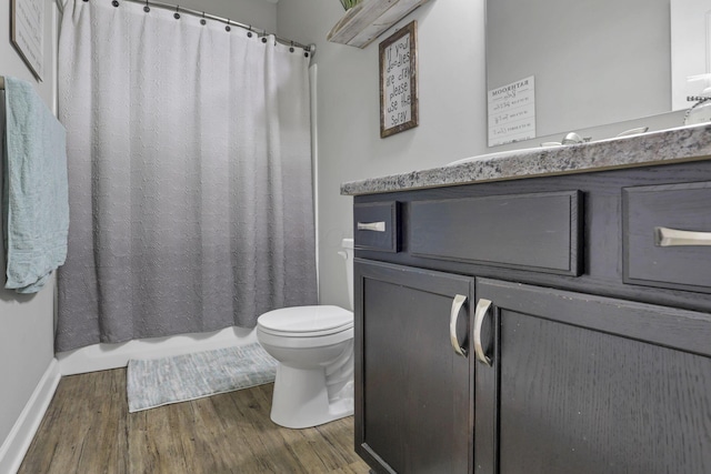 7205 W Grubb Rd NE, Thornville, OH 43076 - bathroom with wood finished floors, vanity, toilet, and baseboards