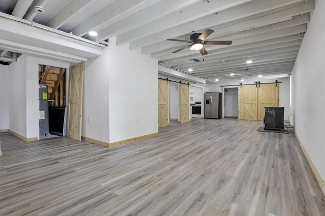 7205 W Grubb Rd NE, Thornville, OH 43076 - below grade area featuring a barn door, stainless steel fridge, water heater, baseboards, and light wood-type flooring