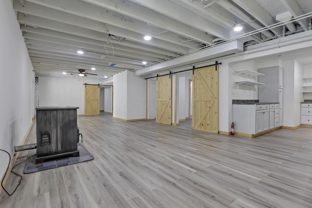 7205 W Grubb Rd NE, Thornville, OH 43076 - below grade area with a barn door, light wood-style flooring, and baseboards