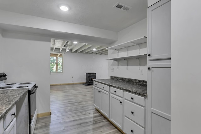 7205 W Grubb Rd NE, Thornville, OH 43076 - kitchen with electric range, open shelves, a wood stove, dark countertops, and baseboards