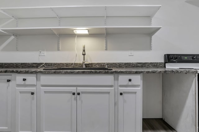 7205 W Grubb Rd NE, Thornville, OH 43076 - kitchen featuring electric stove, a sink, dark countertops, and white cabinets