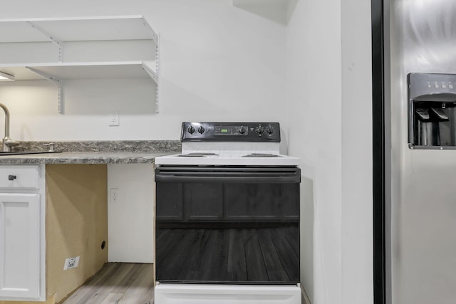 7205 W Grubb Rd NE, Thornville, OH 43076 - kitchen featuring range with electric stovetop, wood finished floors, white cabinets, stainless steel refrigerator with ice dispenser, and a sink