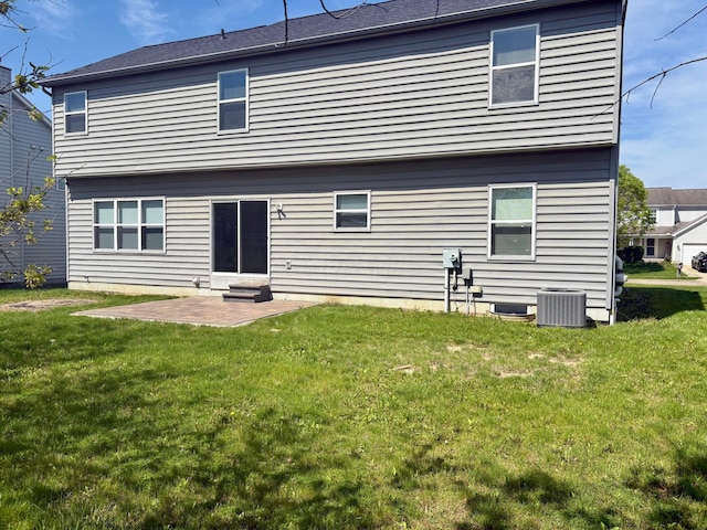 back of house featuring a yard, a patio, and central AC unit