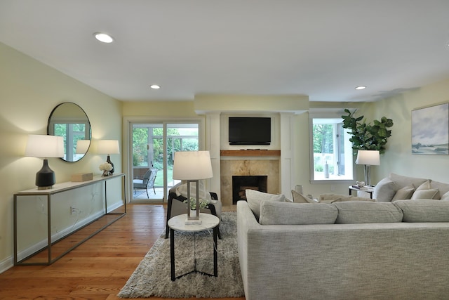 1155 Millcreek Ct, Columbus, OH 43220 - living area with wood finished floors, plenty of natural light, a tile fireplace, recessed lighting, and baseboards