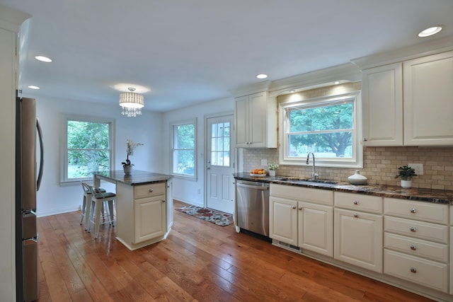 1155 Millcreek Ct, Columbus, OH 43220 - kitchen featuring stainless steel appliances, a sink, light wood finished floors, decorative backsplash, and recessed lighting