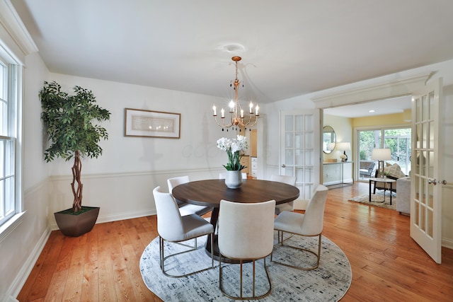 1155 Millcreek Ct, Columbus, OH 43220 - dining room with french doors, a chandelier, light wood-style floors, and baseboards
