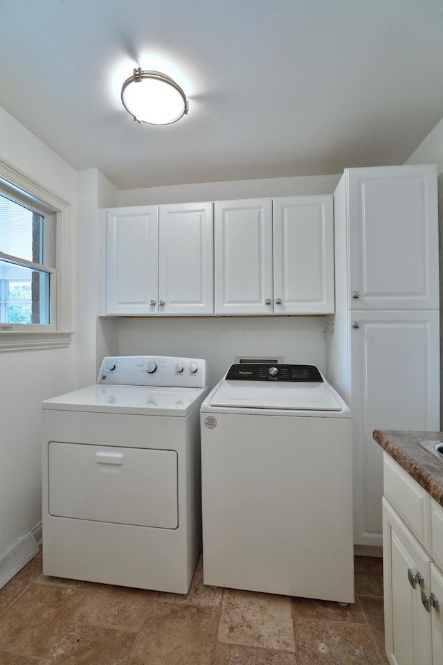 1155 Millcreek Ct, Columbus, OH 43220 - laundry area with washer and clothes dryer, cabinet space, light stone finish floors, and baseboards