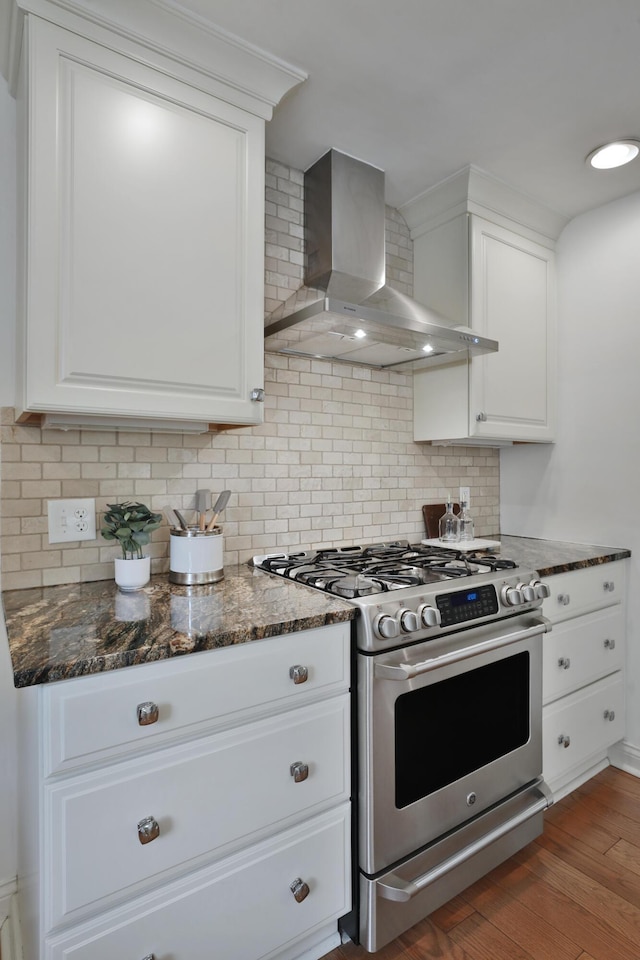 1155 Millcreek Ct, Columbus, OH 43220 - kitchen featuring gas stove, wall chimney exhaust hood, white cabinetry, tasteful backsplash, and wood finished floors