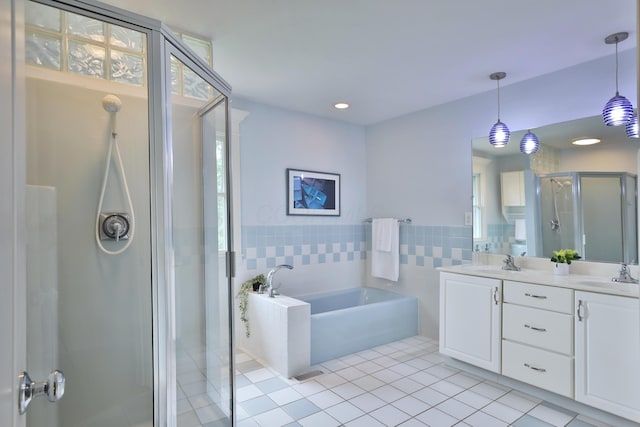 1155 Millcreek Ct, Columbus, OH 43220 - full bathroom with tile patterned flooring, a stall shower, a bath, double vanity, and tile walls