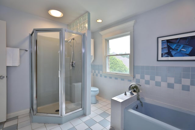 1155 Millcreek Ct, Columbus, OH 43220 - bathroom with a garden tub, a stall shower, toilet, tile patterned floors, and tile walls