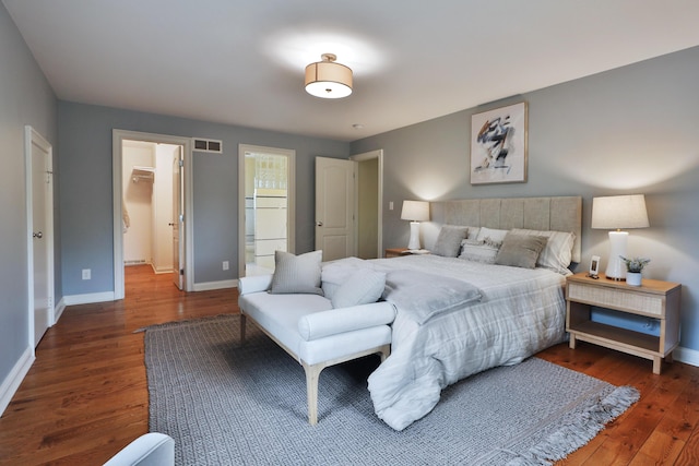 1155 Millcreek Ct, Columbus, OH 43220 - bedroom featuring wood finished floors, baseboards, a spacious closet, and connected bathroom