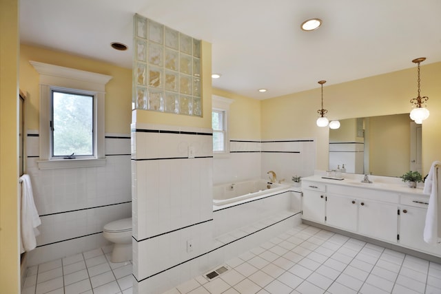 1155 Millcreek Ct, Columbus, OH 43220 - full bath featuring vanity, a jetted tub, tile patterned flooring, toilet, and a wainscoted wall
