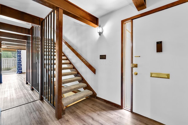 144 W Ticonderoga Dr Unit H, Westerville, OH 43081 - entrance foyer with wood finished floors, beamed ceiling, baseboards, and stairway