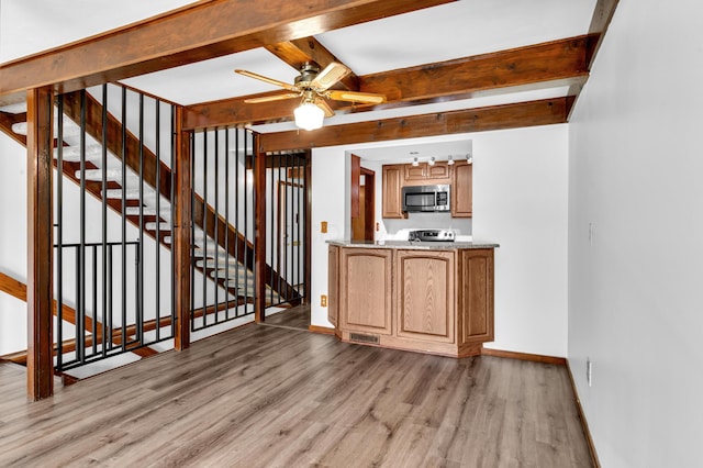 144 W Ticonderoga Dr Unit H, Westerville, OH 43081 - kitchen featuring light wood-style flooring, beamed ceiling, stainless steel appliances, baseboards, and ceiling fan