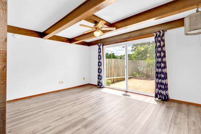 144 W Ticonderoga Dr Unit H, Westerville, OH 43081 - unfurnished room with baseboards, wood finished floors, beam ceiling, and a ceiling fan