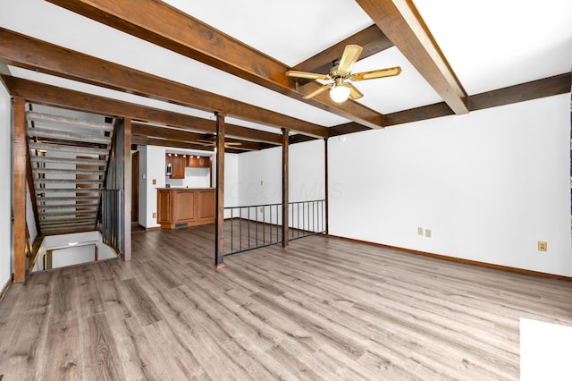 144 W Ticonderoga Dr Unit H, Westerville, OH 43081 - unfurnished living room featuring wood finished floors, beamed ceiling, ceiling fan, and baseboards