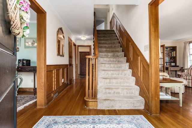 2731 E Broad St, Bexley, OH 43209 - stairway featuring wood finished floors, a wainscoted wall, and ornamental molding