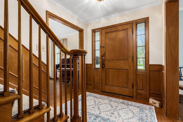 2731 E Broad St, Bexley, OH 43209 - foyer entrance with wood finished floors, stairs, crown molding, and a wainscoted wall