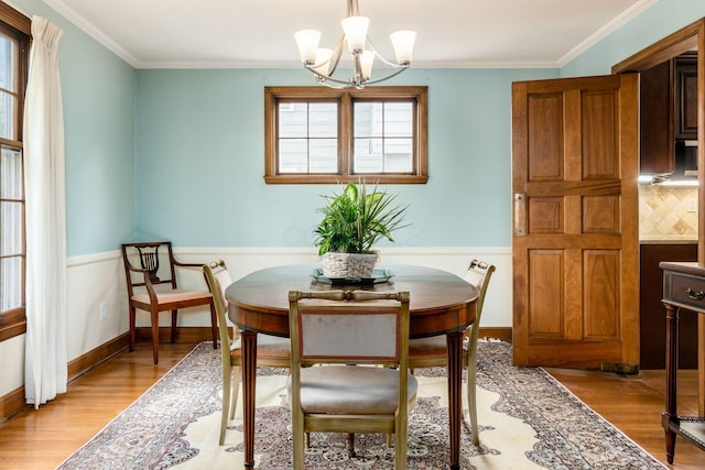 2731 E Broad St, Bexley, OH 43209 - dining space featuring light wood-style flooring, ornamental molding, and a chandelier