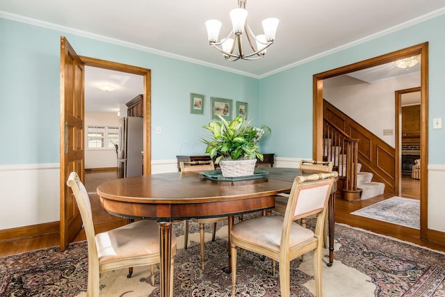 2731 E Broad St, Bexley, OH 43209 - dining room with a chandelier, wood finished floors, stairway, and crown molding