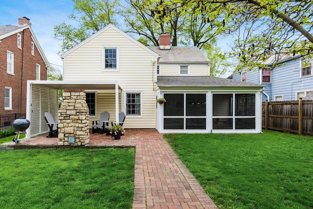 2731 E Broad St, Bexley, OH 43209 - rear view of property featuring a chimney, a patio, and a sunroom