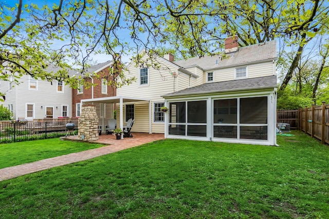 2731 E Broad St, Bexley, OH 43209 - rear view of house featuring a sunroom, a patio area, a chimney, and a shingled roof