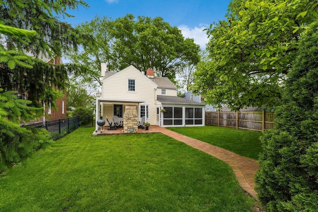 2731 E Broad St, Bexley, OH 43209 - rear view of property with a sunroom, a chimney, and a patio area