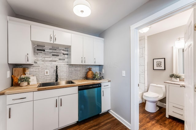 686 Frebis Ave, Columbus, OH 43206 - kitchen with dishwasher, a sink, dark wood-style floors, tasteful backsplash, and white cabinets