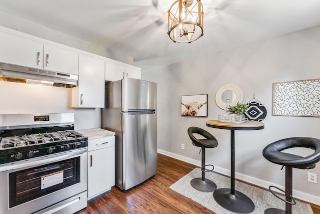 686 Frebis Ave, Columbus, OH 43206 - kitchen featuring stainless steel appliances, under cabinet range hood, dark wood-style flooring, and white cabinetry