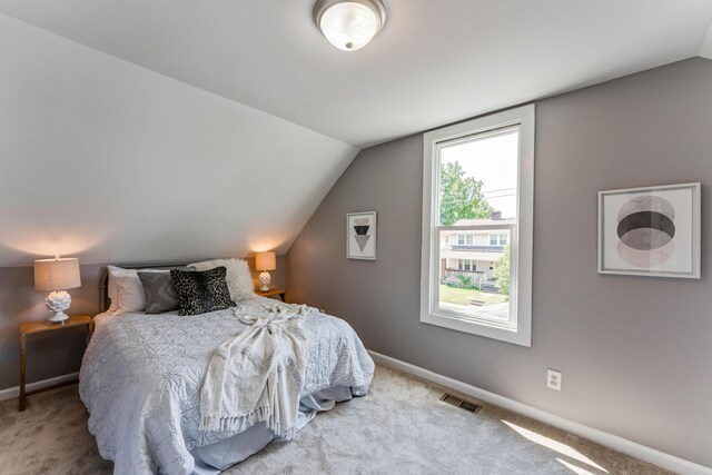 686 Frebis Ave, Columbus, OH 43206 - bedroom with vaulted ceiling, carpet floors, and baseboards