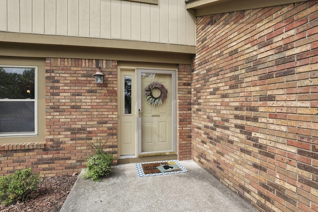 view of exterior entry with brick siding