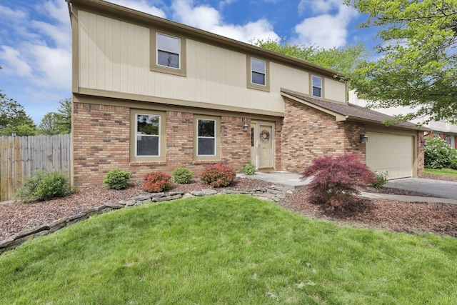 view of front of property with brick siding, driveway, and a garage