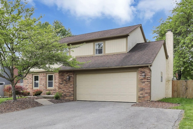 view of front of house with asphalt driveway, brick siding, an attached garage, fence, and a chimney