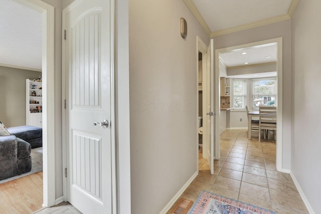 corridor featuring crown molding and baseboards