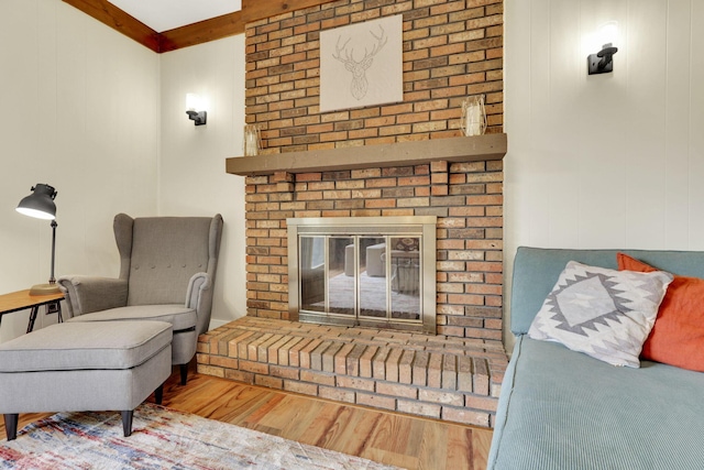 living area with wood finished floors and a fireplace