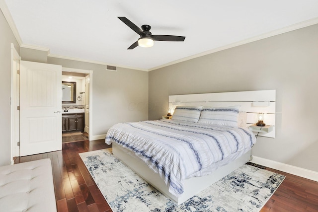 bedroom featuring dark wood finished floors, ornamental molding, baseboards, a ceiling fan, and connected bathroom