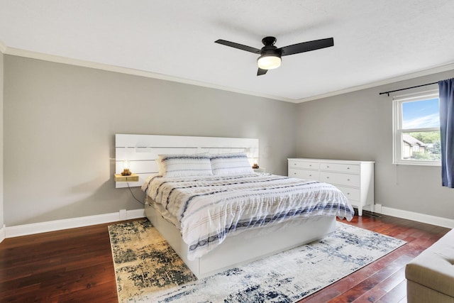 bedroom featuring dark wood finished floors, baseboards, ornamental molding, and a ceiling fan