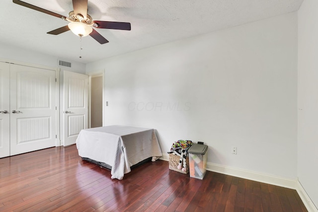 bedroom with baseboards, wood-type flooring, ceiling fan, and a closet