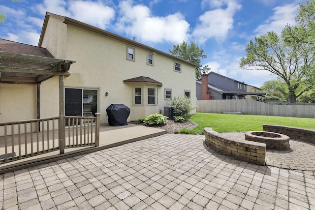 view of patio featuring a fire pit, central air condition unit, a wooden deck, and a pergola
