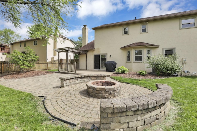 rear view of house featuring a pergola, a patio, and stucco siding